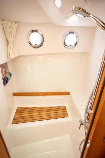 Everything Is Fine Yacht Photos Pics Shower area in 2019 Beneteau Swift Trawler 30 with portholes and wooden accents.