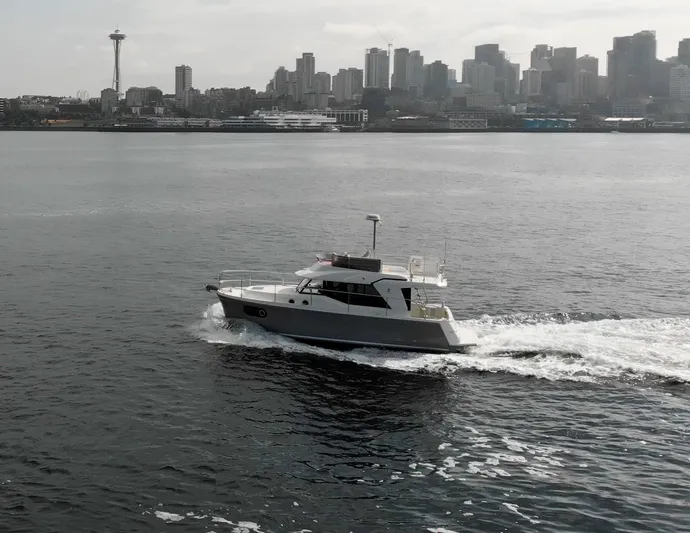 Everything Is Fine Yacht Photos Pics 2019 Beneteau Swift Trawler 30 cruising near city skyline and iconic tower.
