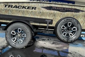 2026 Tracker Grizzly 1650 T Prairie Wings Edition trailer with stylish wheels and camouflage design.