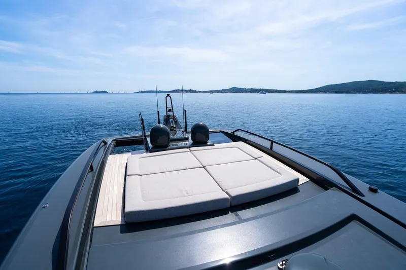  Yacht Photos Pics Luxurious 2025 Bluegame BGX 63 yacht with sunbathing deck on calm sea.