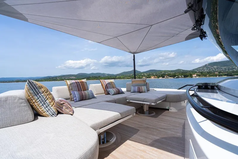  Yacht Photos Pics Luxurious 2025 Bluegame BGX 63 yacht deck with plush seating and scenic water view.