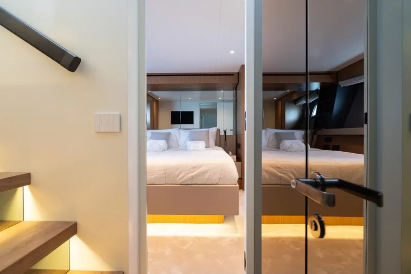  Yacht Photos Pics Luxurious bedroom interior on 2025 Bluegame BGX 63 yacht, featuring modern design and elegant lighting.