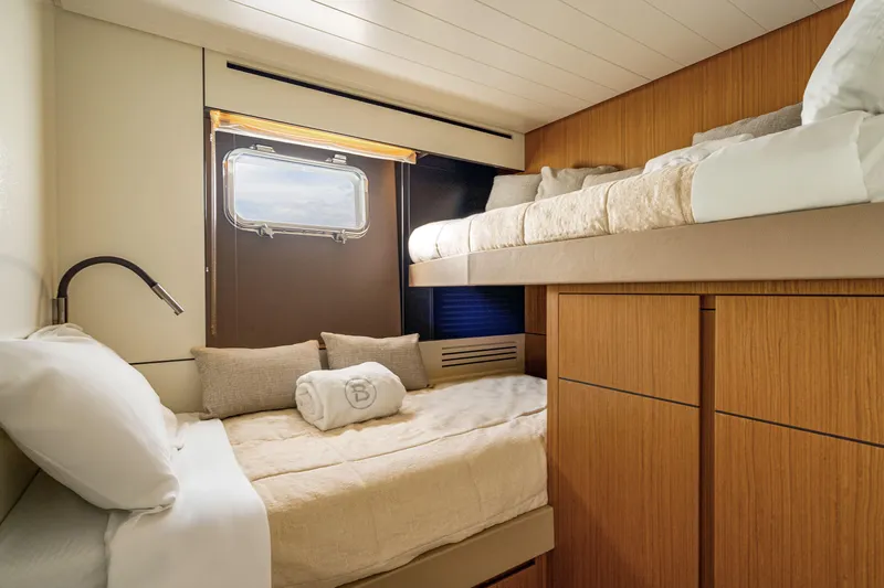  Yacht Photos Pics Luxurious cabin interior of 2025 Bluegame BGX 63 yacht with cozy bedding.