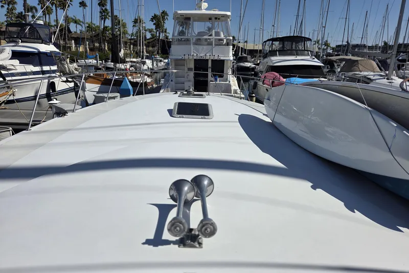 Halcyon Yacht Photos Pics 1984 Magnum Marine 53 yacht docked in a marina, surrounded by other boats.