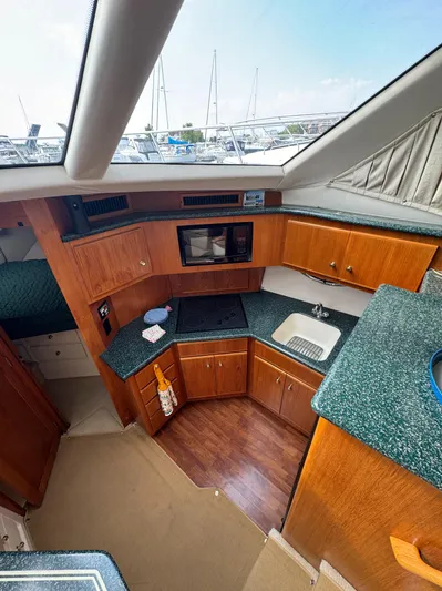 Logos Yacht Photos Pics Interior of 2000 Carver 406 Aft Cabin Motor Yacht with modern kitchen amenities.