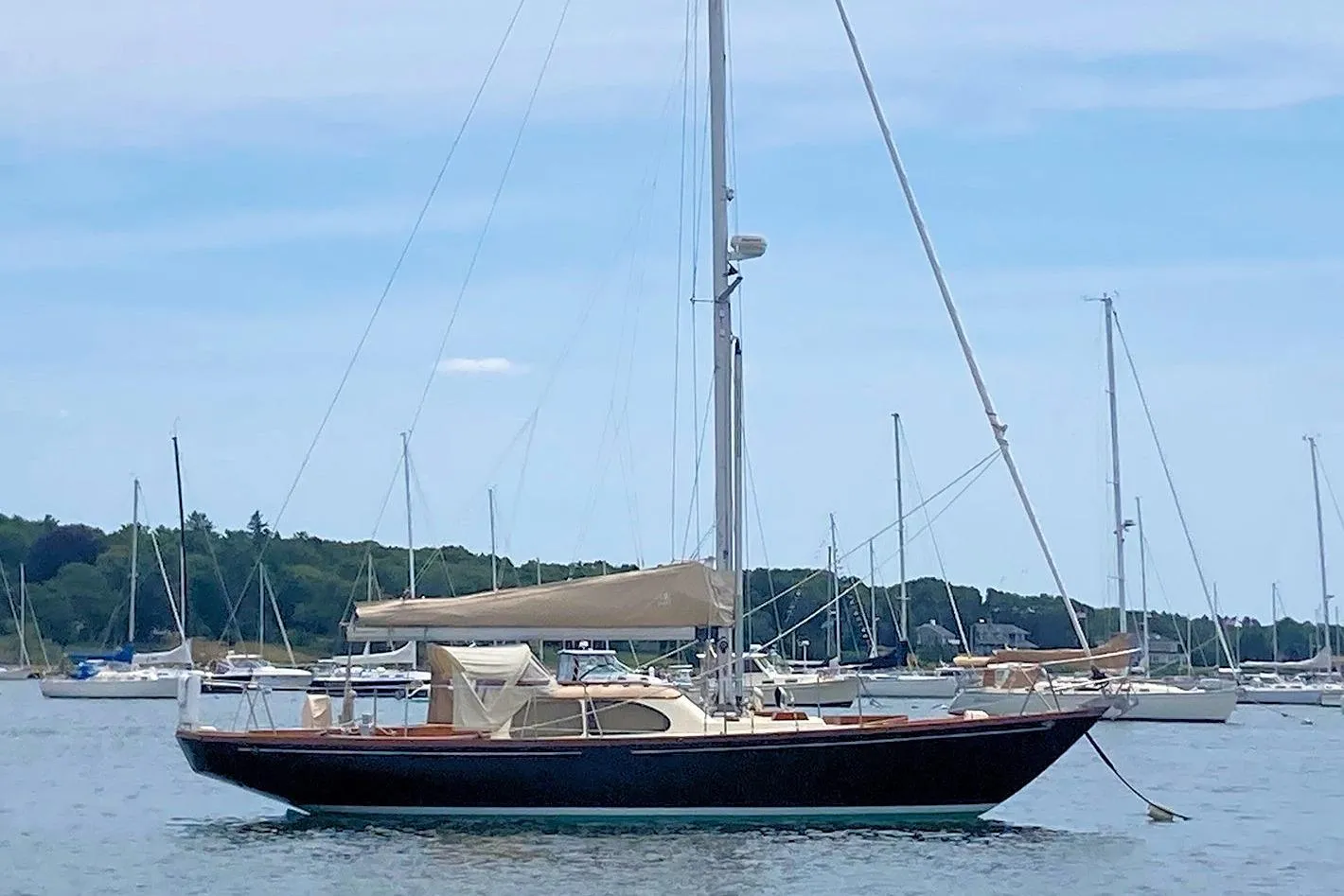 1967 Columbia Constellation sailboat anchored in a serene harbor setting.