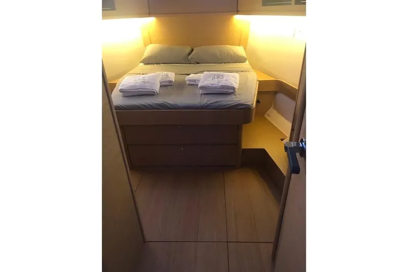  Yacht Photos Pics Cozy cabin interior of 2019 Dufour 460 Grand Large yacht with neatly arranged bed.