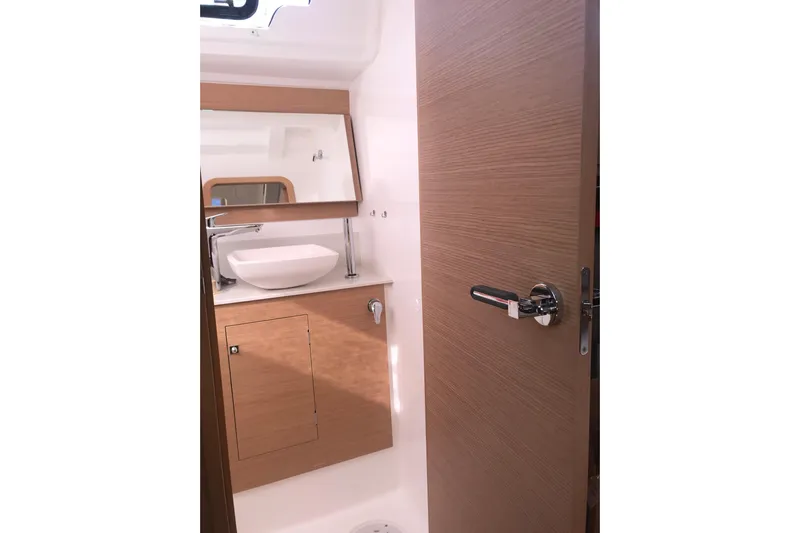  Yacht Photos Pics 2019 Dufour 460 Grand Large yacht bathroom with modern sink and wooden cabinetry.