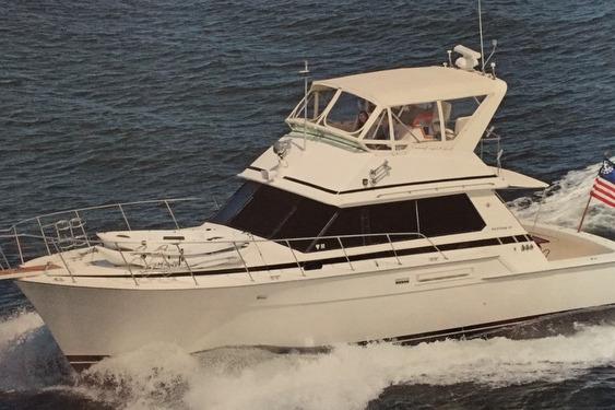 1987 Bertram 42 Convertible yacht cruising on open water.