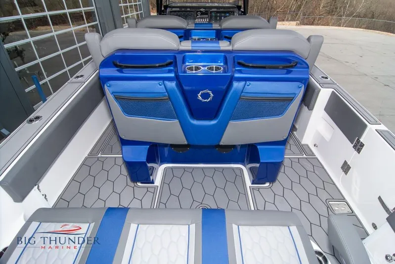  Yacht Photos Pics 2022 Fountain 38 SC boat interior with blue and gray seating, hexagonal flooring.
