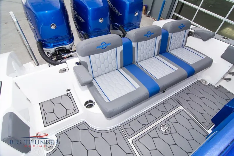  Yacht Photos Pics 2022 Fountain 38 SC boat interior with blue and gray seating and flooring.