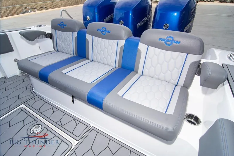  Yacht Photos Pics 2022 Fountain 38 SC boat seating with blue and gray upholstery, featuring logo and modern design.