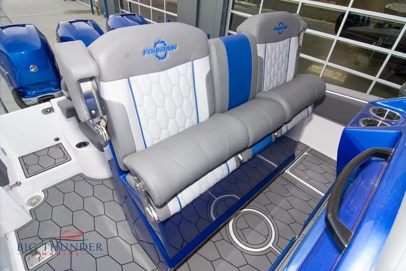  Yacht Photos Pics 2022 Fountain 38 SC boat interior with blue and gray seating and hexagonal flooring.