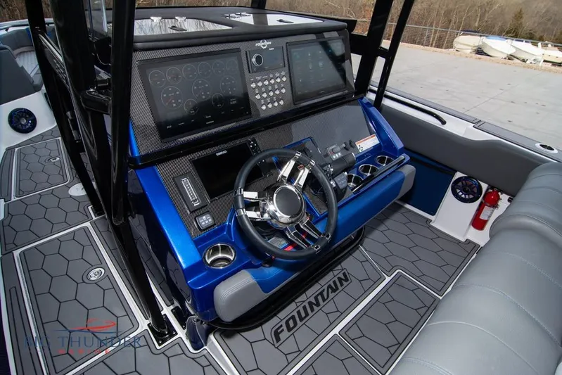  Yacht Photos Pics 2022 Fountain 38 SC boat cockpit with modern dashboard and steering wheel.