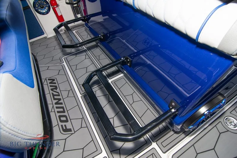  Yacht Photos Pics 2022 Fountain 38 SC boat interior with blue seating and geometric flooring design.