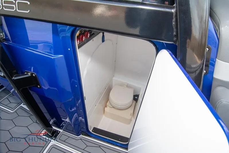  Yacht Photos Pics 2022 Fountain 38 SC boat interior with compact marine toilet.