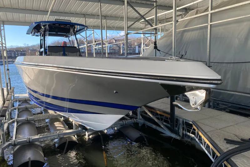  Yacht Photos Pics 2022 Fountain 38 SC boat docked under a covered marina.