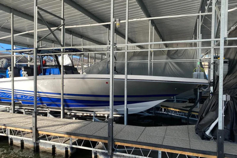  Yacht Photos Pics 2022 Fountain 38 SC boat docked in a covered marina.