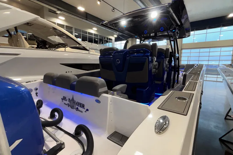  Yacht Photos Pics 2022 Fountain 38 SC boat interior with blue lighting and seating in showroom.