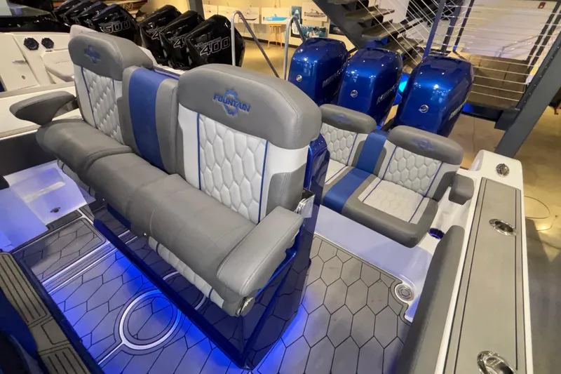  Yacht Photos Pics 2022 Fountain 38 SC boat interior with gray and blue seating, illuminated floor, and powerful engines.