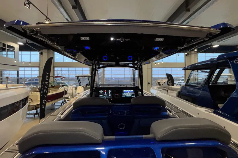  Yacht Photos Pics 2022 Fountain 38 SC boat interior with modern dashboard in showroom setting.