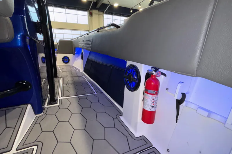  Yacht Photos Pics 2022 Fountain 38 SC boat interior with hexagonal flooring and fire extinguisher.