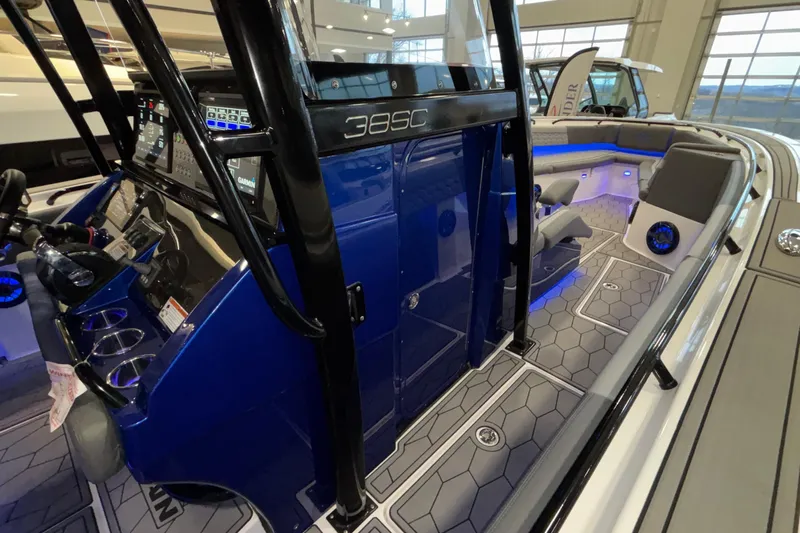  Yacht Photos Pics 2022 Fountain 38 SC boat interior with modern dashboard and seating, featuring blue accents.