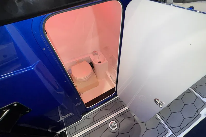  Yacht Photos Pics 2022 Fountain 38 SC boat interior with open door revealing compact bathroom.