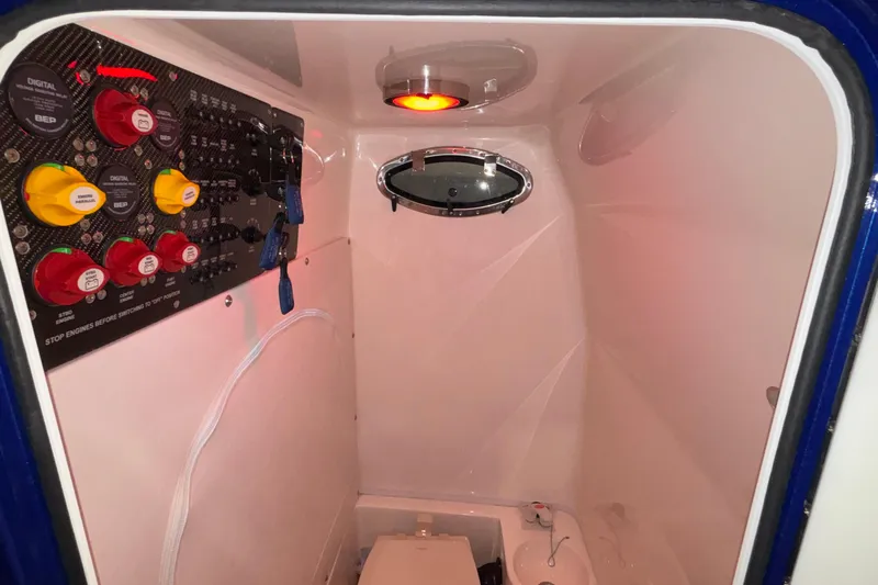  Yacht Photos Pics 2022 Fountain 38 SC boat interior with control panel and porthole window.