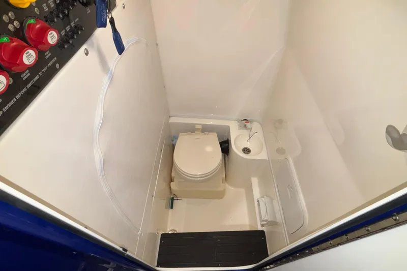 Yacht Photos Pics 2022 Fountain 38 SC boat bathroom with toilet and control panel.