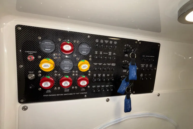  Yacht Photos Pics Control panel of 2022 Fountain 38 SC boat with labeled switches and keys.