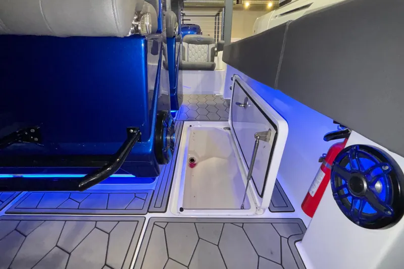  Yacht Photos Pics Interior of 2022 Fountain 38 SC boat with blue lighting and storage compartment.