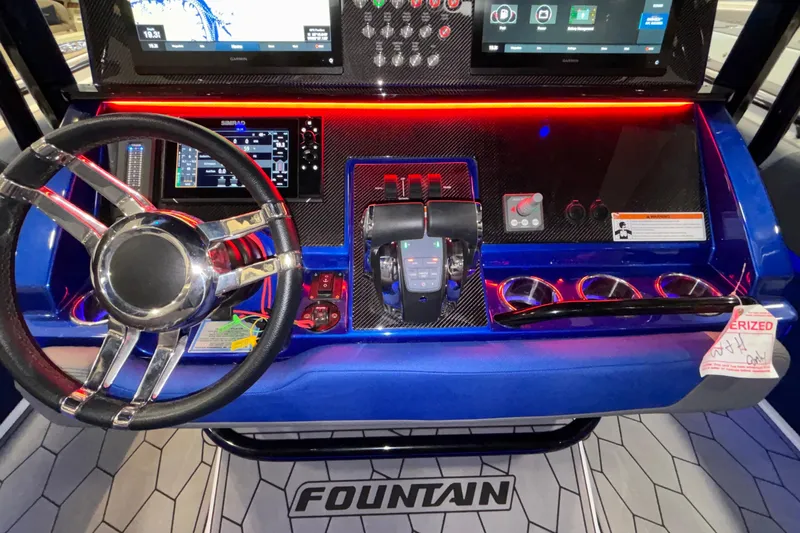  Yacht Photos Pics 2022 Fountain 38 SC boat dashboard with steering wheel, controls, and digital displays.