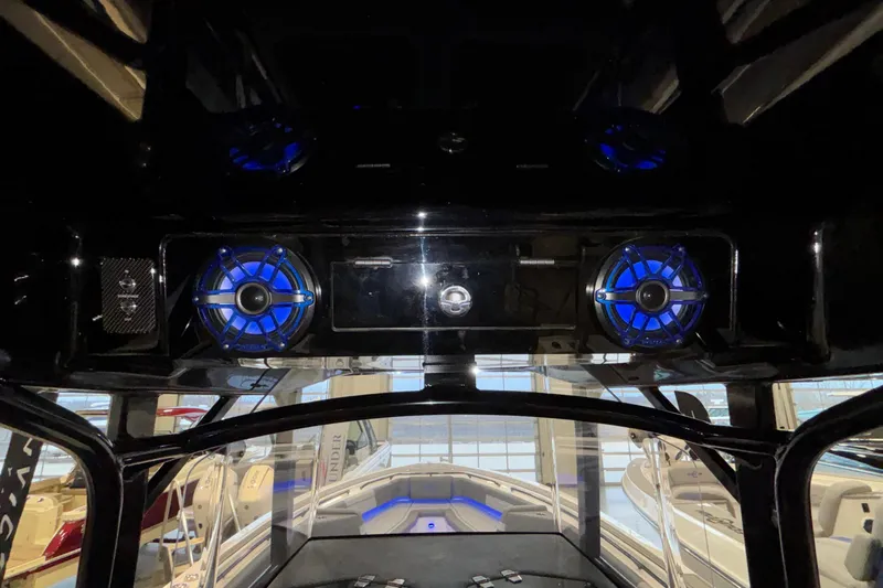  Yacht Photos Pics 2022 Fountain 38 SC boat interior with blue-lit speakers and modern dashboard.