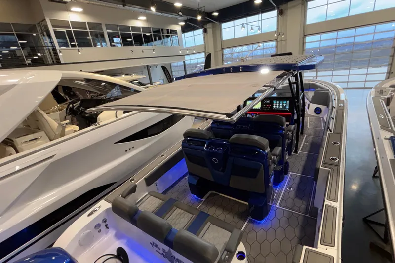  Yacht Photos Pics 2022 Fountain 38 SC boat interior with modern seating and illuminated controls in showroom.