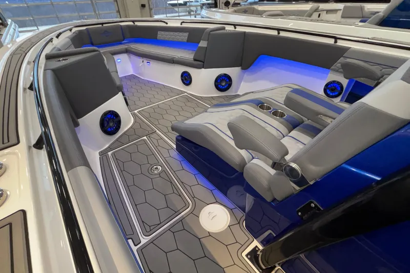  Yacht Photos Pics 2022 Fountain 38 SC boat interior with gray seating, blue LED lighting, and hexagonal flooring.
