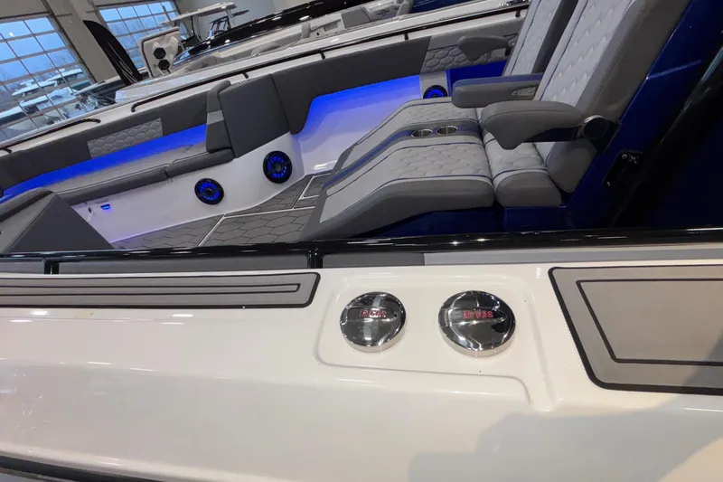  Yacht Photos Pics 2022 Fountain 38 SC boat interior with blue LED lighting and cushioned seating.