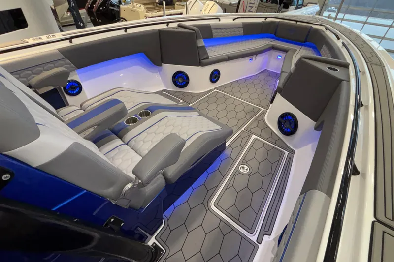  Yacht Photos Pics 2022 Fountain 38 SC boat interior with modern seating, blue LED lighting, and hexagonal flooring.