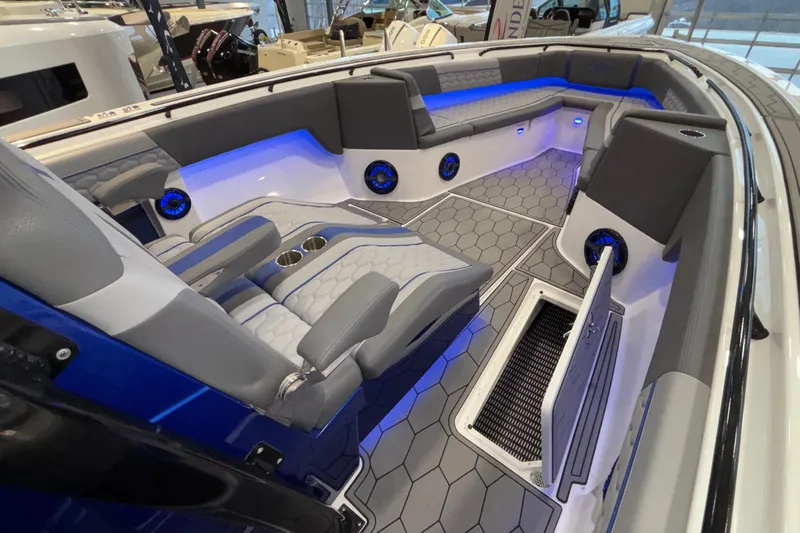  Yacht Photos Pics 2022 Fountain 38 SC boat interior with blue LED lighting and hexagonal flooring.