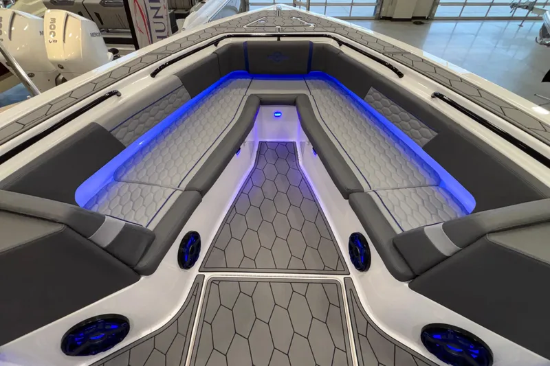  Yacht Photos Pics 2022 Fountain 38 SC boat interior with blue LED lighting and hexagonal-patterned seating.