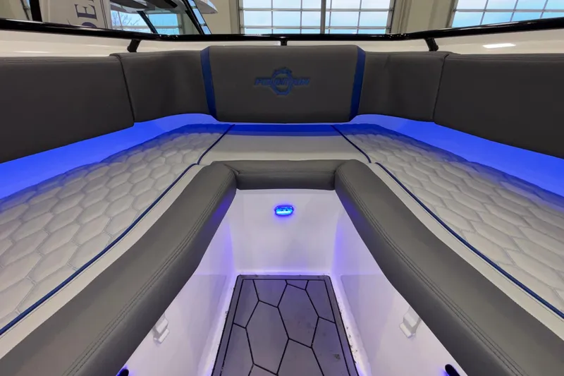  Yacht Photos Pics Interior of 2022 Fountain 38 SC boat with blue LED lighting and cushioned seating.