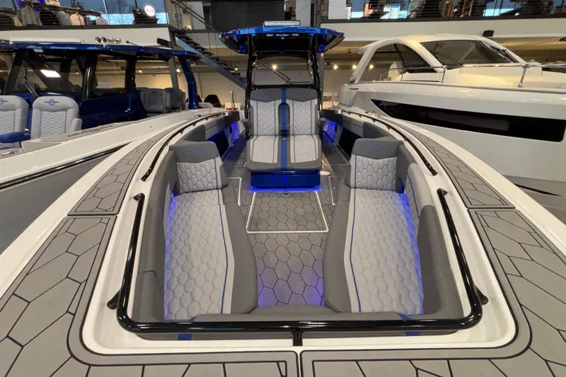 Yacht Photos Pics 2022 Fountain 38 SC boat interior with modern seating and ambient blue lighting.