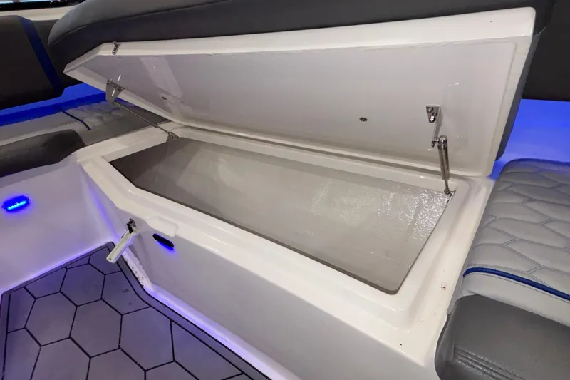  Yacht Photos Pics Open storage compartment in 2022 Fountain 38 SC boat with blue LED lighting.