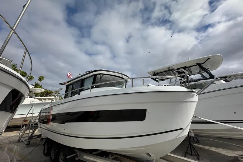  Yacht Photos Pics 2026 Jeanneau NC 895 Sport Series 2 boat displayed outdoors under cloudy sky.