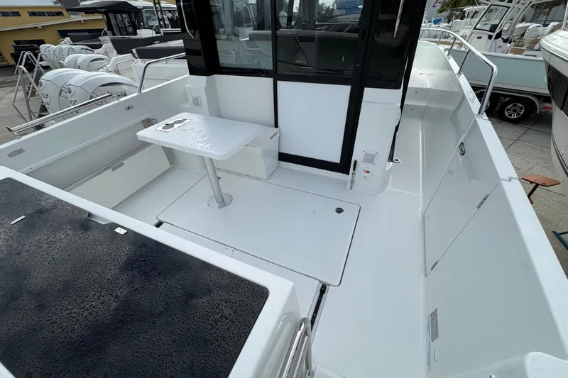  Yacht Photos Pics 2026 Jeanneau NC 895 Sport Series 2 boat deck with seating and table.