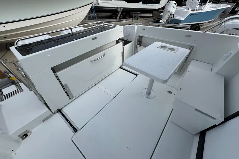  Yacht Photos Pics 2026 Jeanneau NC 895 Sport Series 2 boat interior with table and storage.