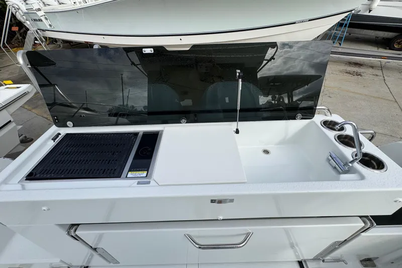  Yacht Photos Pics Outdoor kitchen on Jeanneau NC 895 Sport Series 2, 2026 model, featuring grill and sink.