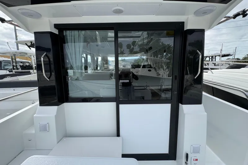  Yacht Photos Pics 2026 Jeanneau NC 895 Sport Series 2 boat with sliding glass door and modern interior.