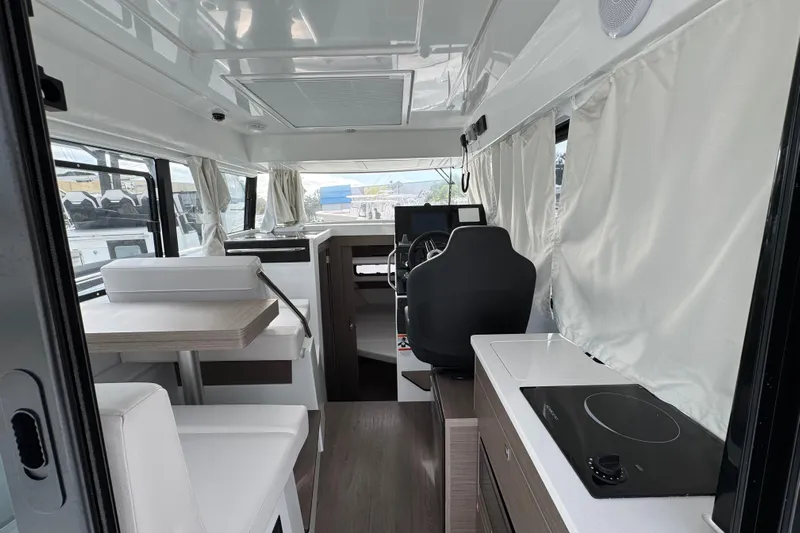  Yacht Photos Pics Interior of 2026 Jeanneau NC 895 Sport Series 2, featuring modern seating and navigation area.
