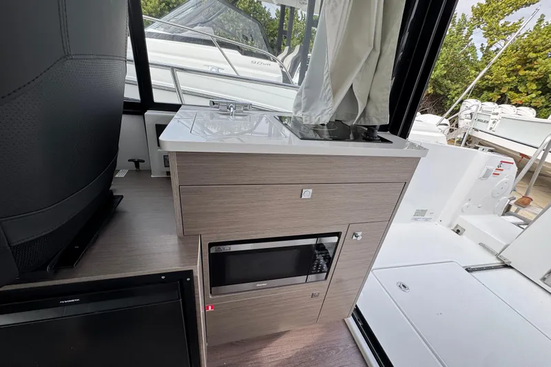  Yacht Photos Pics Interior of 2026 Jeanneau NC 895 Sport Series 2, featuring a compact kitchen area.